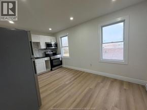 Windsor apartment for rent - A kitchen with a refrigerator, microwave, and oven.