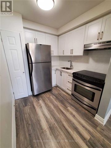 Toronto (Willowdale East) triplex for rent - A kitchen with a stainless steel refrigerator and oven.