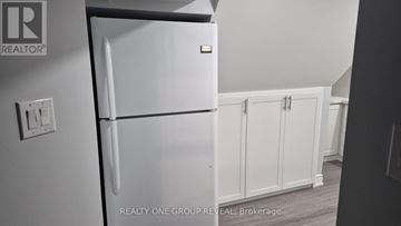 Toronto (Newtonbrook West) house for rent - A white refrigerator in a kitchen with a brokerage logo.