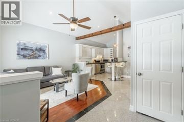 Hamilton house for rent - A living room with a grey couch and a painting on the wall.