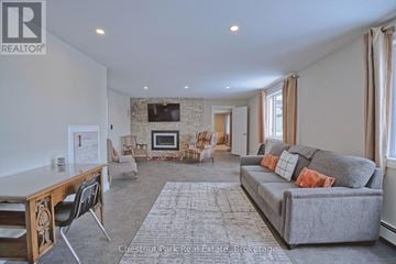 Georgian Bluffs house for rent - A living room with a grey couch and a wooden table.