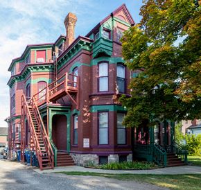 Ann Arbor apartment for rent - a red brick house with green and red stairs