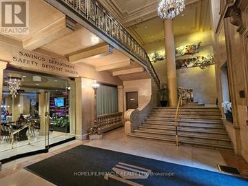 Toronto (Bay Street Corridor) condo for rent - A foyer with a staircase and a sign that says "Savings Department Safety Deposit Vaults".