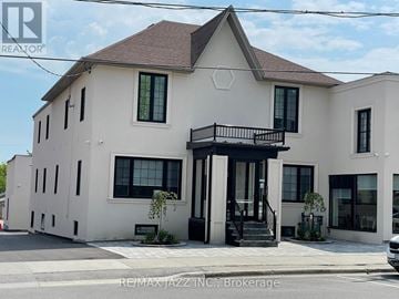 Oshawa (Central) multi-family for rent - A white two-story house with a balcony on the second floor.