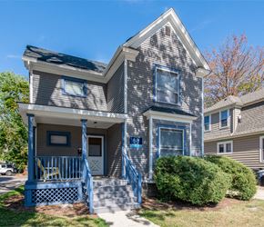 Ann Arbor house for rent - A grey house with a blue door and a small porch.