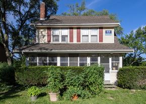 Ann Arbor triplex for rent - A house with a red stripe on the front wall.