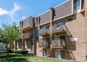 Ann Arbor apartment for rent - a brick apartment building with balconies and trees