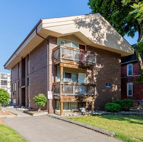 Ann Arbor apartment for rent - a brick apartment building with two balconies and a sidewalk