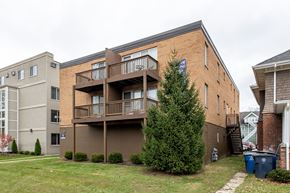Ann Arbor apartment for rent - Apartment complex with a brown building and a tree in front.