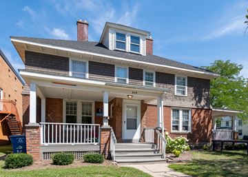 Ann Arbor apartment for rent - A two-story house with a front porch and a white door.