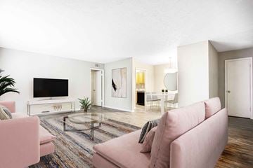 Decatur apartment for rent - A living room with a pink couch and a television.