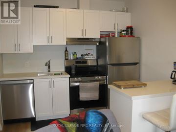Niagara Falls (Morrison) condo for rent - A kitchen with white cabinets and stainless steel appliances.
