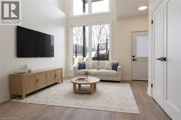Rockwood house for rent - A living room with a white couch and a wooden cabinet.