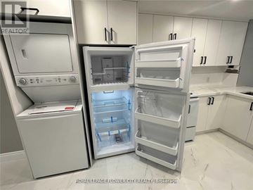 Caledon (Caledon East) house for rent - A white refrigerator with its door open in a kitchen.