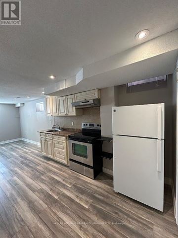 Vaughan (Patterson) townhouse for rent - A kitchen with a white refrigerator and wooden floors.