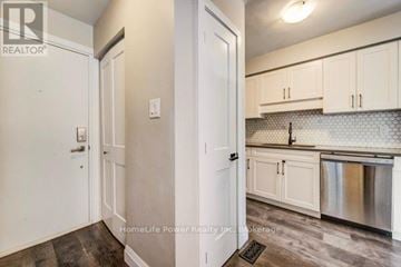 Cambridge townhouse for rent - A kitchen with white cabinets and a stainless steel dishwasher.