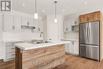 Russell other for rent - A kitchen with a white counter top and wooden cabinets.