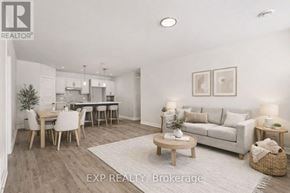 For rent in Russell - A well-lit, spacious living room with a dining area and a kitchen in the background.