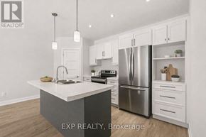 For rent in Russell - A kitchen with white cabinets and a large island.