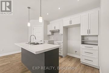 Russell other for rent - A kitchen with white cabinets and a large island.