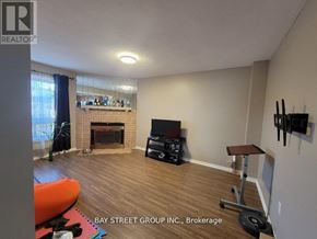 Mississauga (Erin Mills) house for rent - A living room with a fireplace and a television.