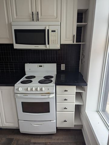 Trenton apartment for rent - A white stove and microwave in a kitchen.