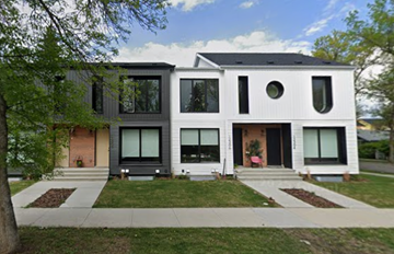 Edmonton apartment for rent - A modern two story house with a black roof and white walls.