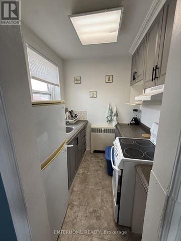 Brampton (Downtown Brampton) condo for rent - A small, clean kitchen with a washer and dryer.