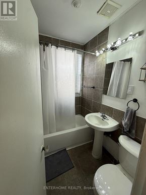 Brampton (Downtown Brampton) condo for rent - A bathroom with a toilet, sink, and shower.