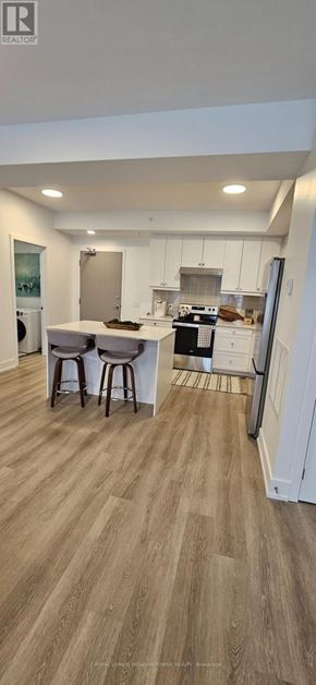 Kawartha Lakes (Fenelon Falls) condo for rent - A kitchen with wooden flooring and white walls.