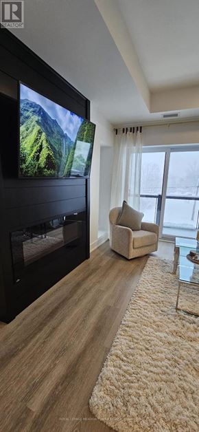 Kawartha Lakes (Fenelon Falls) condo for rent - A modern living room with a flat screen TV and a fireplace.