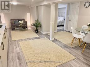 Richmond Hill (Crosby) house for rent - A living room with a couch, a chair, and a dining table.