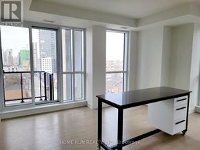 Ottawa condo for rent - A black and white desk in a room with a view of the city.