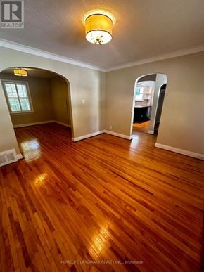 Toronto (Willowdale East) house for rent - A room with wooden floors and a large mirror on the wall.