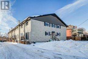 Cambridge townhouse for rent - A house with a snow-covered ground in front of it.