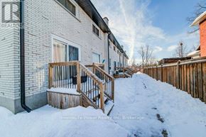 Cambridge townhouse for rent - A snow-covered front yard of a residential building.