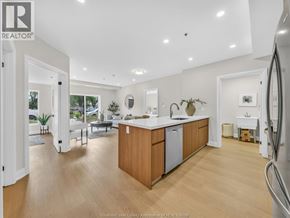 Windsor condo for rent - A kitchen with wooden cabinets and a refrigerator.