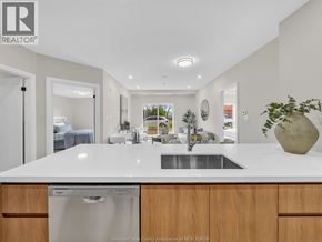 Windsor condo for rent - A modern kitchen with a large island and a dishwasher.