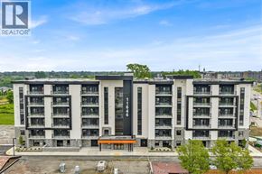 Windsor condo for rent - A large building with a sign that says REALTOR on it.