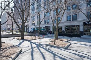 Hamilton condo for rent - A tree-lined walkway in front of a building with a sign that says "Macy's.".