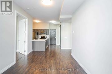 Hamilton (Beasley) condo for rent - A room with a kitchenette and a refrigerator in it.
