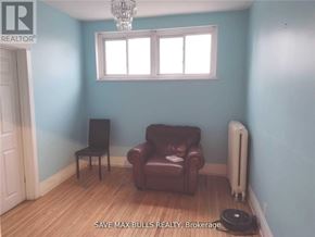 Hamilton (Central) condo for rent - A room with a brown leather chair and a white radiator.