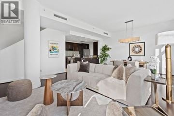 Vancouver townhouse for rent - A modern living room with a white couch and a coffee table.
