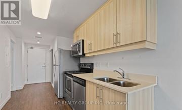 Waterloo condo for rent - A kitchen with wooden cabinets and stainless steel appliances.
