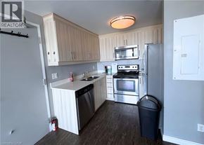 Waterloo condo for rent - A kitchen with a refrigerator, oven, and sink.