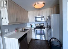 Waterloo condo for rent - A kitchen with a refrigerator, stove, and microwave.