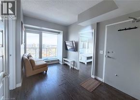 Waterloo condo for rent - A living room with a couch, chair, and television.