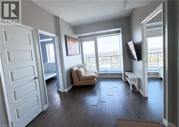 Waterloo condo for rent - A living room with a couch and a television.