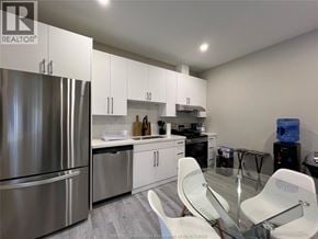 Windsor house for rent - A modern kitchen with stainless steel appliances and white cabinets.