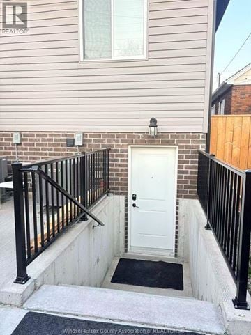 Windsor house for rent - A kitchen with black cabinets and a white island.
